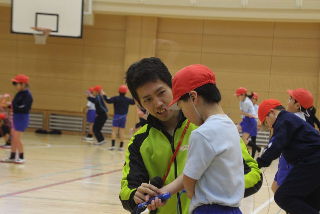 なわとびが苦手な子へ個別に声をかける指導風景